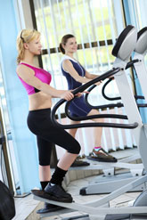 people exercising equipment in a health club